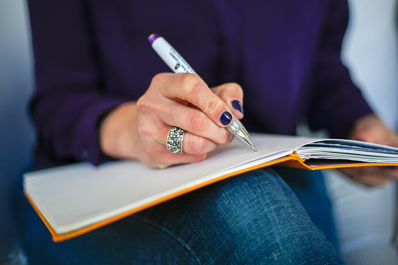 Checklist ticked off in a notebook beside a phone